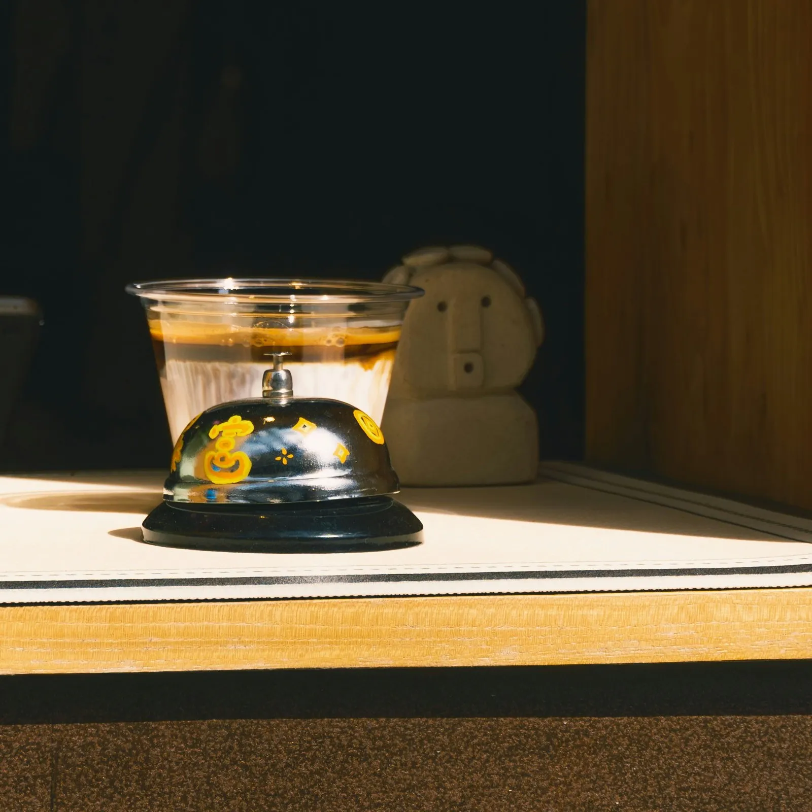 A service bell on a sunlit wooden ledge: support for existing clients