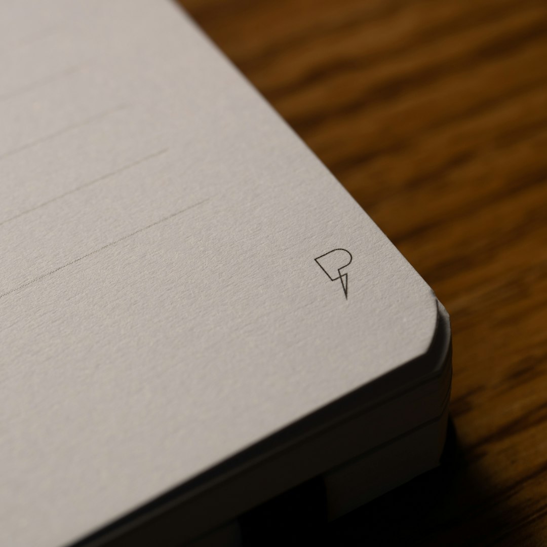 Handwritten notes beside a laptop: pinning down the requirements